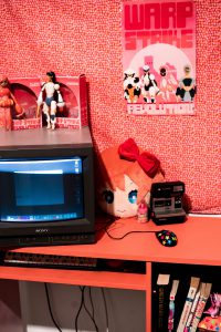 Red table with CRT TV sitting on the red table.