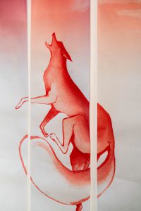 Art hung from the wall depicting an animal howling into the air.