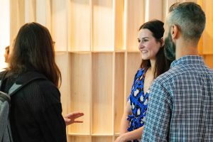 People smiling at the opening of the DMA senior show Pressed for Space.