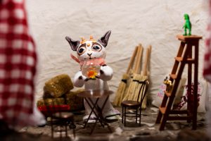 Interior of a sculpture with an animal figurine holding a goldfish in a bowl