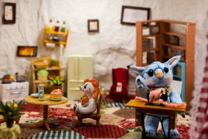 Interior of a sculpture with animal figurines cooking food.