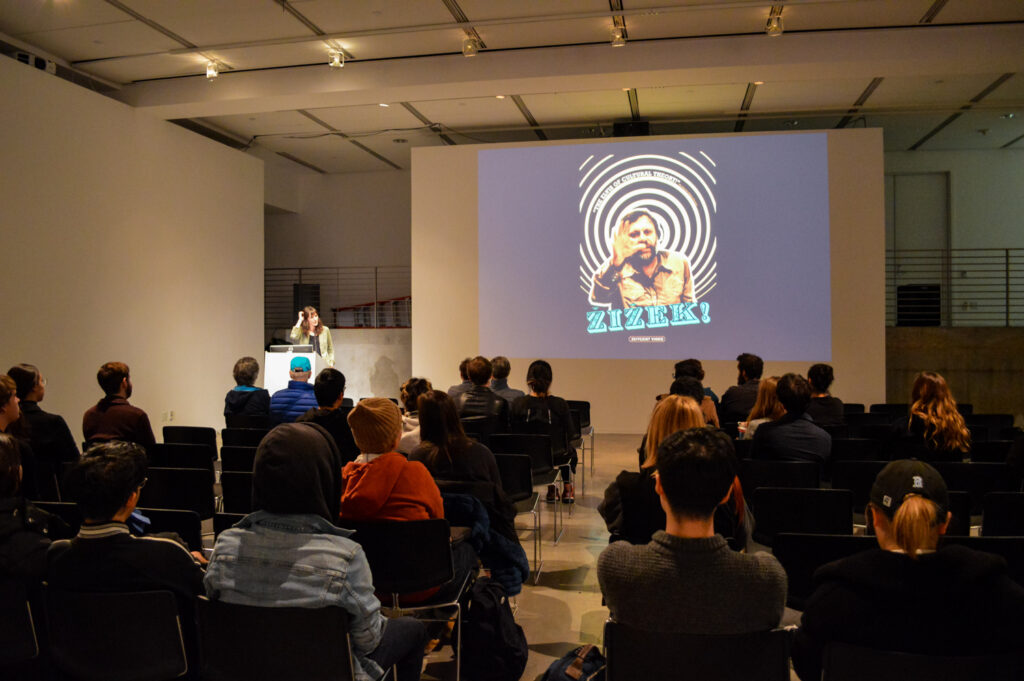 Poster of Zizek is displayed on the screen.
