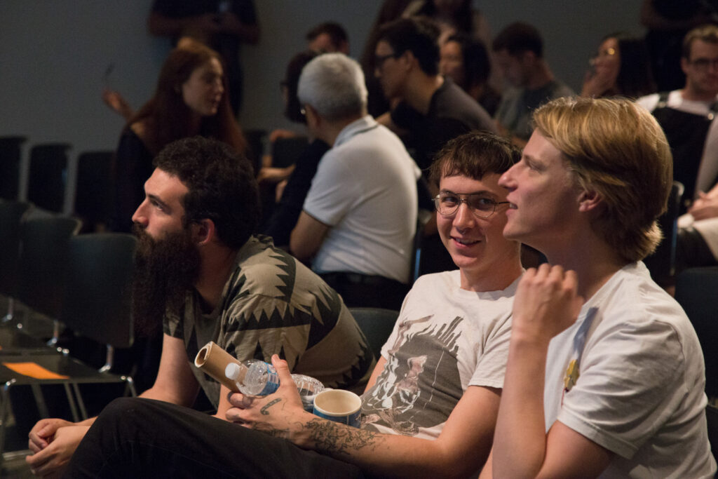 Audience members talking to each other.