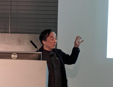 Masaki Fujihata speaking from the podium.