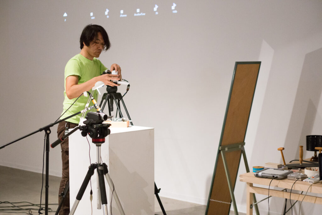 Toshio Iwai preparing for his lecture.