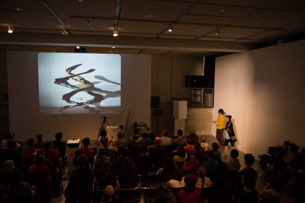 Live slit screening video manipulation of Toshio Iwai in front of a wall.