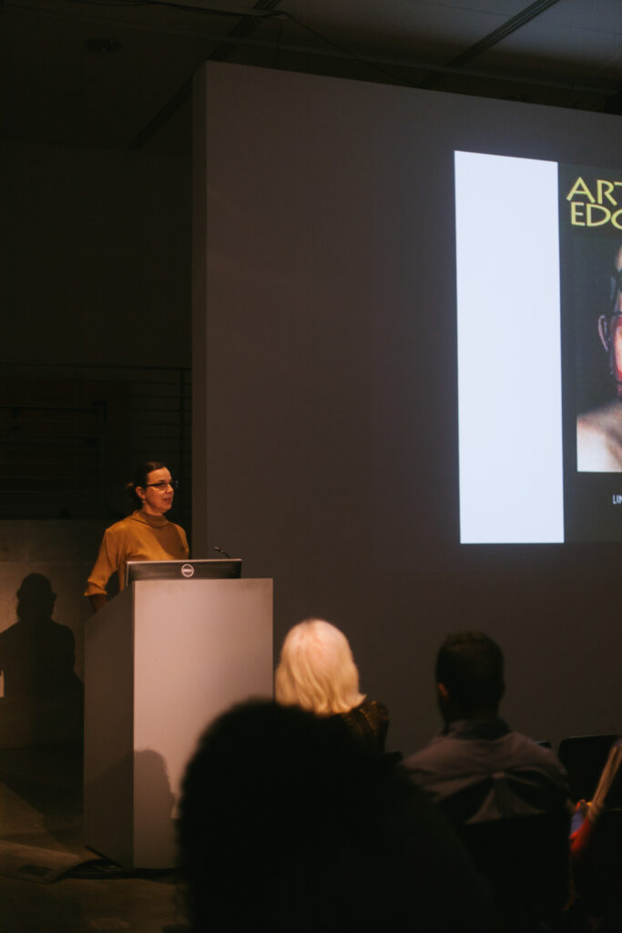 Person standing at a pedestal during Weintrab's lecture.