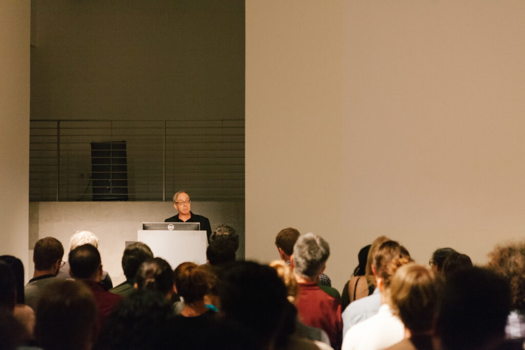 Person is standing at a pedestal introducing Zizek.