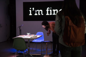 The words "I'm fine" is being projected on a wall.