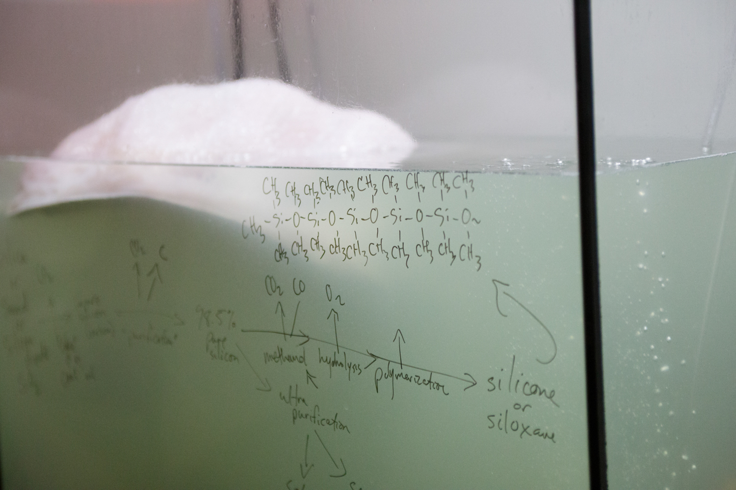 Formula for silocone is written on an aquarium tank.