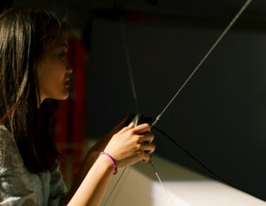 Person holding a video game controller during YOUJIN CHUNG's solo show.