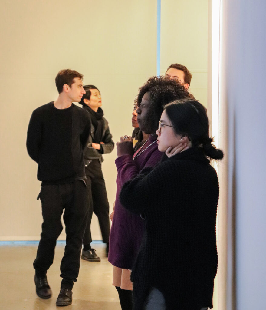 Brenda Williams and Helen Tran look at Harvey Moon's projection work.