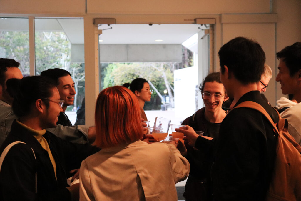 People giving a toast to each other at the opening of Zheng Fang's exhibition.