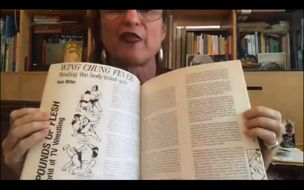 MCKENZIE WARK opens a book on their webcam to show the audience Wing Chung Fever.