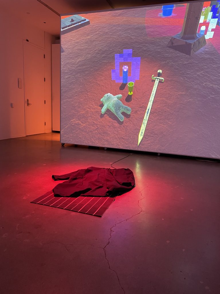 Rug with black fabric ontop. Video game Projection on wall