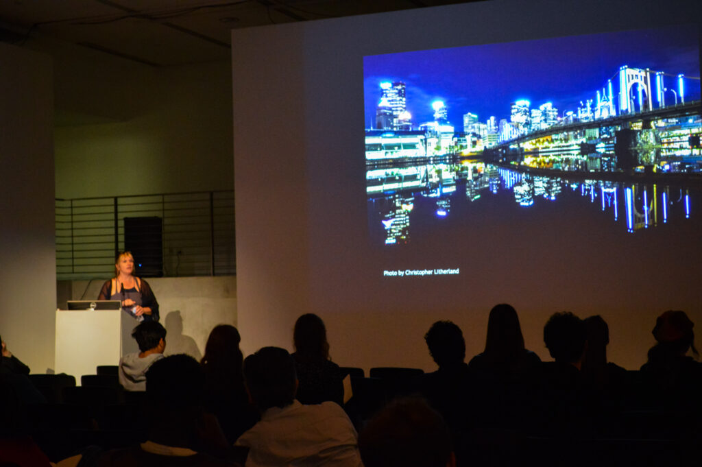 Photo of a city at night by Christopher Litherland is projected on the EDA pit wall.