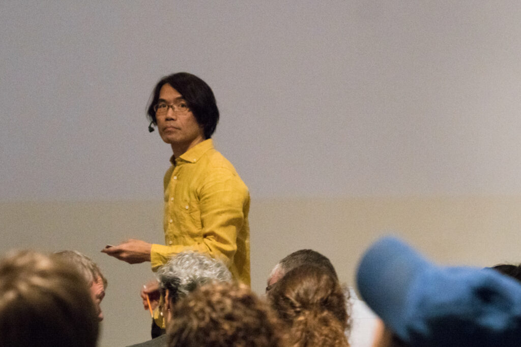 Toshio Iwai is staring at the audience.
