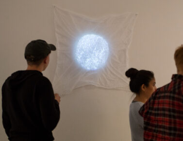 Circular projection on top of white fabric at Sam Congdon's solo show.
