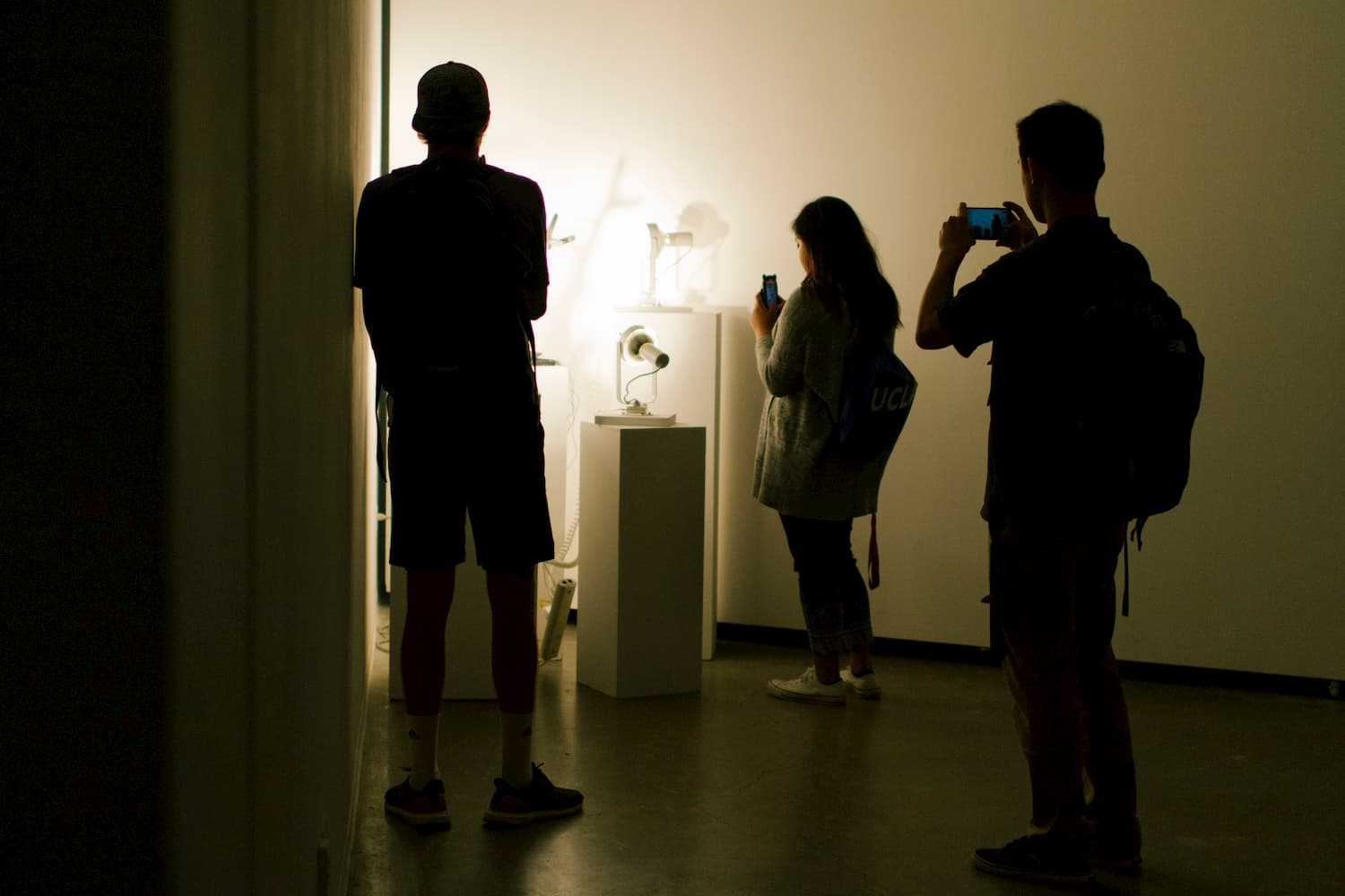Series of lamps aimed toward a wall during YOUJIN CHUNG's solo show.