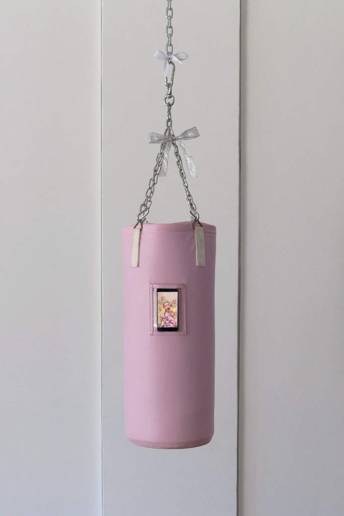 Pink punching bag with clear pocket. Cell phone inside clear pocket.