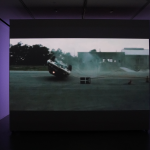 Video projection showing car flipped upside down